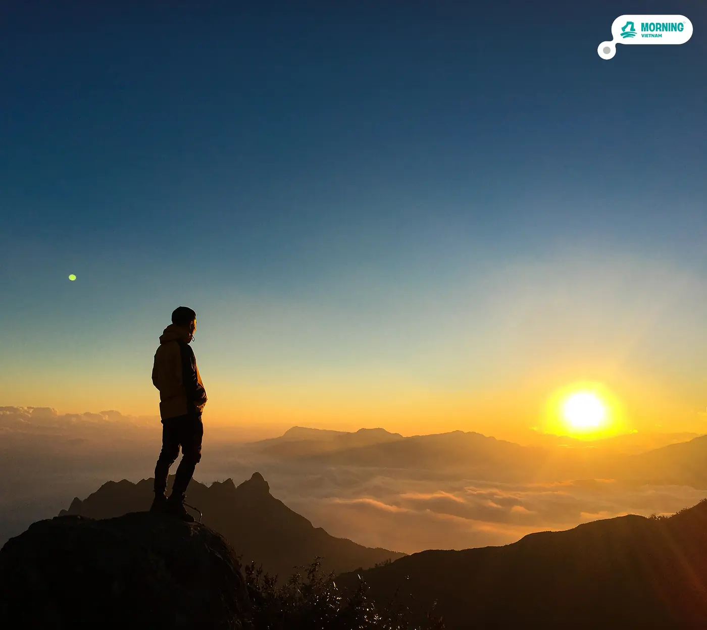 Sunrise glow over layered mountain ridges