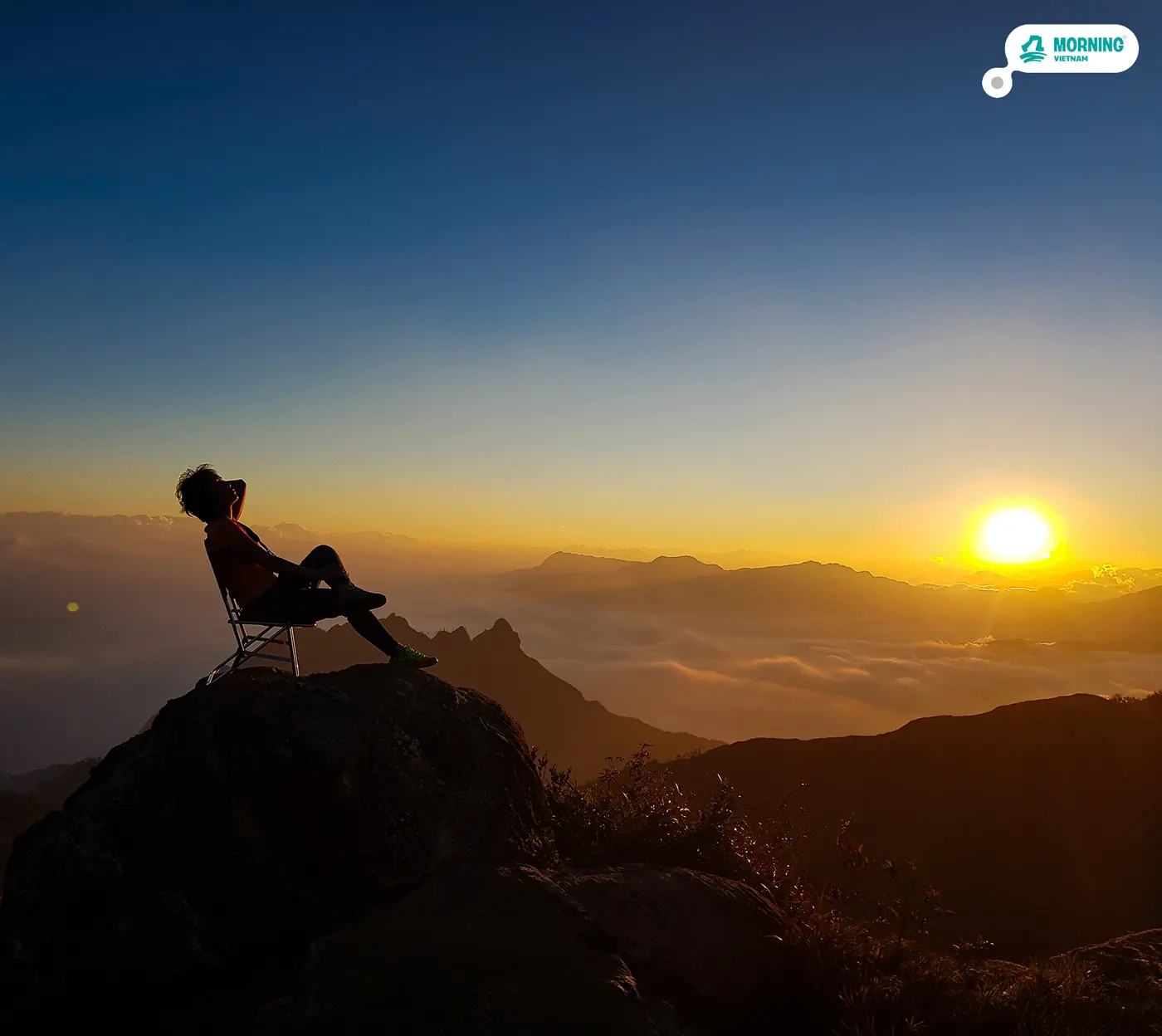 Resting on the ridge at golden hour above the clouds