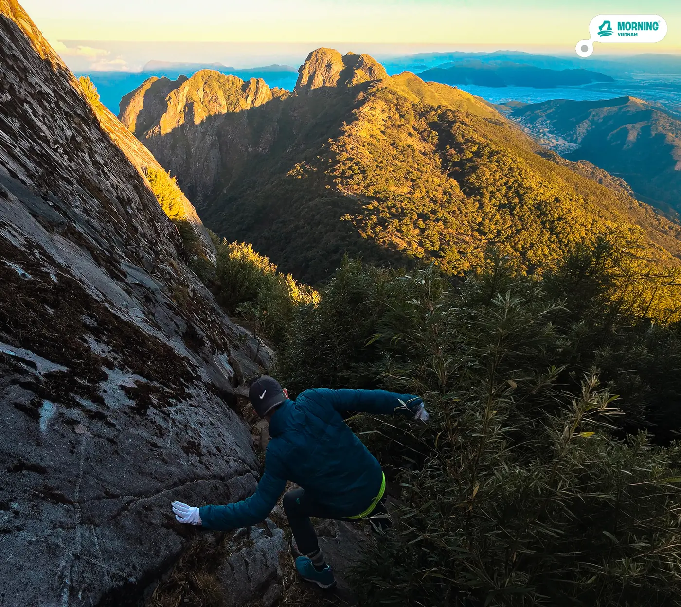 Scrambling along an exposed rock face near the summit